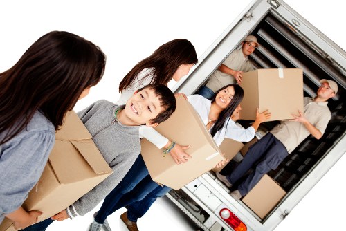 Moving team delivering boxes and furniture to a new property in France