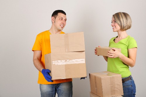 Staff using protective equipment while carrying furniture