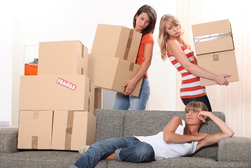 Professional movers loading household items into a removal van